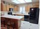 Galley style kitchen with dark countertops and black appliances at 7829 E Naranja Ave, Mesa, AZ 85209