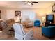 Bright living room featuring comfortable seating, including recliners, and a ceiling fan at 7829 E Naranja Ave, Mesa, AZ 85209