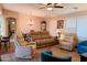 Spacious living room with a neutral color scheme, comfortable seating, and a view into the dining area at 7829 E Naranja Ave, Mesa, AZ 85209