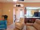 Open concept living room with a view of the kitchen and entryway. Recliners and a blue accent chair are present at 7829 E Naranja Ave, Mesa, AZ 85209