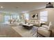 Bright and spacious living room with adjacent dining area, staged with modern furniture at 9098 S 256Th Ln, Buckeye, AZ 85326