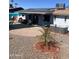 Charming backyard featuring a covered patio, hot tub, and desert landscaping at 10443 W Butler Dr, Peoria, AZ 85345