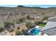 Aerial view showing a home with a pool, desert landscape, and mountain background at 13487 W Roy Rogers Rd, Peoria, AZ 85383