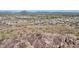 Aerial view of a house nestled in a mountainous area with desert landscape at 13487 W Roy Rogers Rd, Peoria, AZ 85383