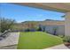 Landscaped backyard with artificial turf, patio, and mountain views at 13487 W Roy Rogers Rd, Peoria, AZ 85383