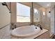 Relaxing bathroom with oval soaking tub and walk-in shower at 13487 W Roy Rogers Rd, Peoria, AZ 85383