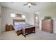 Main bedroom with wood bed frame, ensuite bathroom access, and ample space at 13487 W Roy Rogers Rd, Peoria, AZ 85383