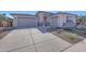 Two-car garage and front yard with drought-tolerant landscaping at 13487 W Roy Rogers Rd, Peoria, AZ 85383