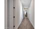 Long hallway with light walls and wood-look tile flooring at 13487 W Roy Rogers Rd, Peoria, AZ 85383