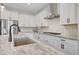 Modern kitchen with white cabinets, quartz countertops, and a hexagon backsplash at 13487 W Roy Rogers Rd, Peoria, AZ 85383