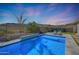 Inviting swimming pool with a water feature and lounge chairs at 13487 W Roy Rogers Rd, Peoria, AZ 85383