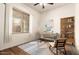 This room features a large window for natural light and ample space for a desk and bookshelf at 13737 W Luke Ave, Litchfield Park, AZ 85340