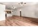 Open-concept living room and kitchen area with wood floors and ceiling fans at 13737 W Luke Ave, Litchfield Park, AZ 85340