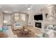 Spacious living room featuring a fireplace and built-in shelving at 16502 W Arroyo Ct, Surprise, AZ 85374