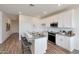 Modern kitchen with white cabinets, granite countertops, and island at 18116 W Cielo Grande Ave, Surprise, AZ 85387