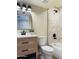 Stylish bathroom showcasing a wooden vanity, sleek black fixtures, and elegant marble-look tiling in the shower area at 2500 N Hayden Rd # 19, Scottsdale, AZ 85257