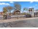 Rancho Mirage community entrance with a landscaped sign and picnic pavilion, near a serene pond at 37730 W Padilla St, Maricopa, AZ 85138