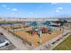 Elevated view of a vibrant playground within the community, featuring diverse play equipment and shaded areas at 37730 W Padilla St, Maricopa, AZ 85138