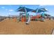 Vibrant community playground featuring modern play structures with slides and shade covers for sunny days at 37730 W Padilla St, Maricopa, AZ 85138