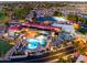 Nighttime aerial view featuring community pool, clubhouse, golf course and surrounding homes at 1560 E Riviera Dr, Chandler, AZ 85249