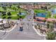 Aerial view of a community with lush landscaping, golf courses, lakes, and well-maintained streets at 1560 E Riviera Dr, Chandler, AZ 85249