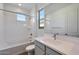 Bright bathroom with soaking tub, vanity, and window at 26367 S 231St Way, Queen Creek, AZ 85142