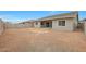 View of the home's backyard featuring an unfinished landscape and a covered patio at 44713 N 44Th Dr, Phoenix, AZ 85087