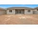 View of the back exterior of the home, showcasing a covered patio and large backyard at 44713 N 44Th Dr, Phoenix, AZ 85087