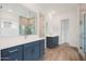 Bright bathroom featuring double vanity, wood-look tile floor, and a large tiled shower at 44713 N 44Th Dr, Phoenix, AZ 85087
