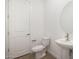 Powder room featuring pedestal sink, white walls and wood-look tile floor at 44713 N 44Th Dr, Phoenix, AZ 85087