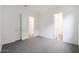 Large bedroom featuring neutral carpeting, white walls, and direct access to multiple rooms at 44713 N 44Th Dr, Phoenix, AZ 85087
