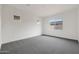 Bedroom featuring neutral carpeting, white walls, and multiple windows at 44713 N 44Th Dr, Phoenix, AZ 85087