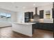 Modern kitchen with a large island, sleek cabinetry, stainless steel appliances, and stylish backsplash at 44713 N 44Th Dr, Phoenix, AZ 85087
