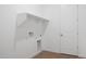 Laundry room with white walls, shelving, and wood-look tile floor at 44713 N 44Th Dr, Phoenix, AZ 85087