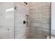Modern shower with sleek tile design, glass door and built-in shower niche at 44713 N 44Th Dr, Phoenix, AZ 85087