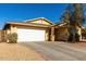 House exterior showcasing a white garage door and gravel driveway at 12640 W Florence St, Avondale, AZ 85323