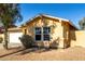 Yellow single story house with a white garage door and gravel landscaping at 12640 W Florence St, Avondale, AZ 85323