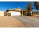 Single-story house with a white garage door and desert landscaping at 12640 W Florence St, Avondale, AZ 85323