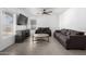 Living room featuring gray sofas, a round coffee table, and a large TV at 12640 W Florence St, Avondale, AZ 85323