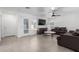 Living room with gray sofas, a coffee table, and a large TV at 12640 W Florence St, Avondale, AZ 85323