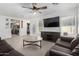 Spacious living room with gray sofas and a view into the kitchen at 12640 W Florence St, Avondale, AZ 85323