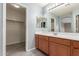 Double sink bathroom with wood cabinets and a closet at 15829 W Carmen Dr, Surprise, AZ 85374