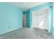 Bedroom with light teal walls, ceiling fan, and closet at 15829 W Carmen Dr, Surprise, AZ 85374