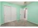 Bedroom with double door closet and access to hallway at 15829 W Carmen Dr, Surprise, AZ 85374