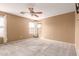 Spacious bedroom with carpeted floors and ceiling fan at 15829 W Carmen Dr, Surprise, AZ 85374