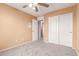 Bedroom with neutral walls, ceiling fan and closet at 15829 W Carmen Dr, Surprise, AZ 85374