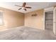 Bright bedroom with access to kitchen and ceiling fan at 15829 W Carmen Dr, Surprise, AZ 85374