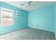 Light teal bedroom with a ceiling fan and window at 15829 W Carmen Dr, Surprise, AZ 85374