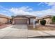 Single-story home with a two-car garage and landscaped front yard at 15829 W Carmen Dr, Surprise, AZ 85374