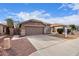 Charming one-story home with a front yard and two-car garage at 15829 W Carmen Dr, Surprise, AZ 85374